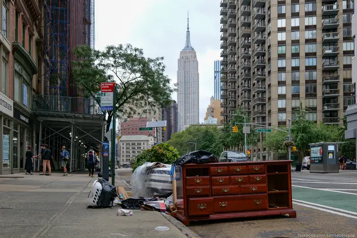 Furniture and trash strewn on a NYC street.